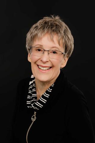 Janice Jensen Author photo - black shirt on black background (web-resolution 1)