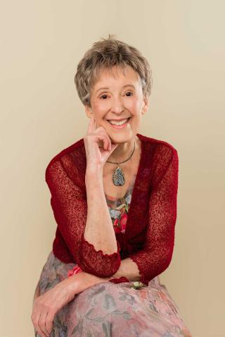 Janice Jensen Author photo - red sweater on cream background (web-resolution 1)